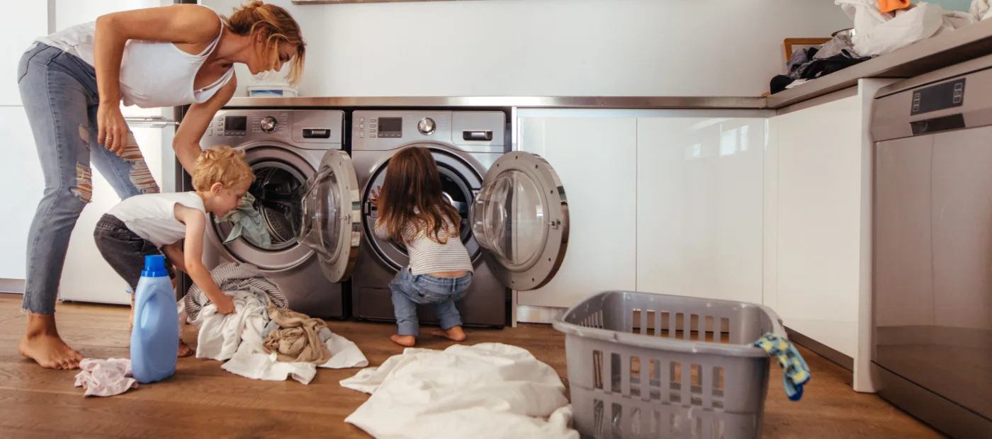 Woman and 2 children in a laundry room