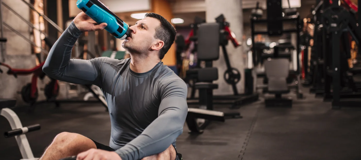 Man drinking water at the gym